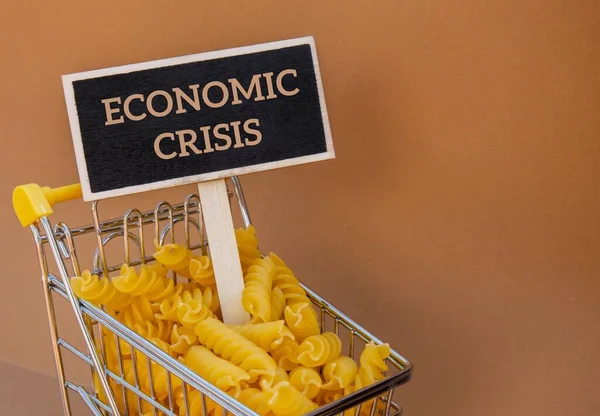 Economic Crisis Text Blackboard Label Shopping Trolley Cart Filled Pasta — 스톡 사진