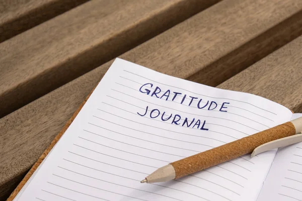 stock image Writing Gratitude Journal on wooden bench. Today I am grateful for. Self discovery journal, self reflection creative writing, self growth personal development concept. Self care wellbeing spiritual