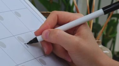 Kadın el yazısı Aylık Planlamacı 'da işaretli olarak borca giriyor. Ayın günlerine göre bayram için manyetizma kurulundan randevu alıyorum. Önemli konuları girebileceğiniz bir yer. Beyaz tahta