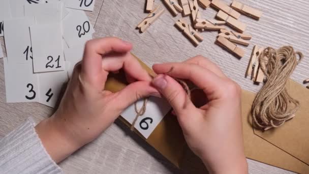 Unrecognizable Young Woman Sticks Number Craft Bag Fastens Clothespin Female — Stock Video