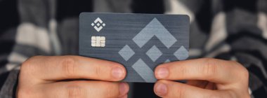 Gdansk Poland - 20 June 2022. Unrecognizable woman showing her Black Binance Coin Card. Visa debit card BNB, Binance Exchange Cryptocurrency Card to buy bitcoin. Crypto exchange during the market