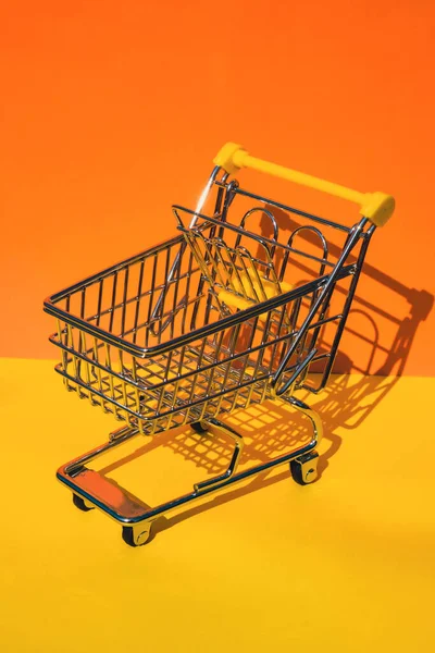 Empty Shopping Trolley Cart Colorful Orange Yellow Background Copy Space — Stock Photo, Image