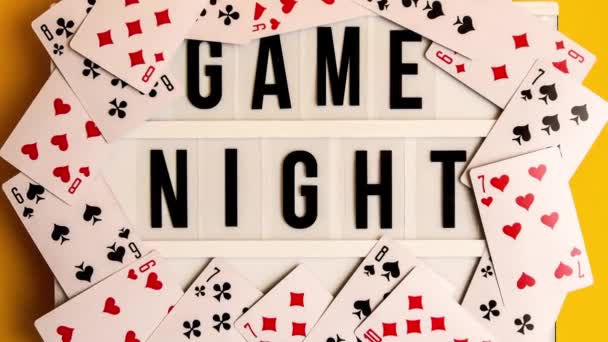 Zoom Out Game Night Text Lightbox Playing Cards Yellow Background — Stock Video