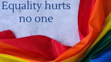 4k gökkuşağı bayrağını mesajla yakınlaştır. Eşitlik kimseye zarar vermez. İpek kumaştan yapılmış gökkuşağı lgbtq bayrağı. LGBTQ gurur ayının sembolü. Eşit haklar. Barış ve özgürlük. LGBTQ topluluğunu destekle