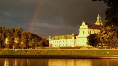 Heavy rain and rainbow above the Vistula river in Krakow Poland. Stunning views of the city rainy season and rainbow. Sky, panoramic views. 