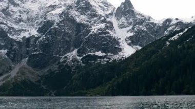 Tatra National Park, Poland. Famous Mountains Lake Morskie Oko Or Sea Eye Lake In autumn. Snow covered mountain peaks on background. Blue water nature landscape 4k