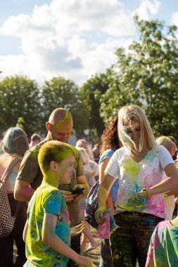 Gdansk, Polonya - Ağustos 2022. Holi Festivali Kutlamaları Mutlu gençlerden oluşan bir kalabalık renk festivali sırasında renkli Holi tozları atan insanların eğlencesine katılıyor. Dışarıda eğleniyoruz. 