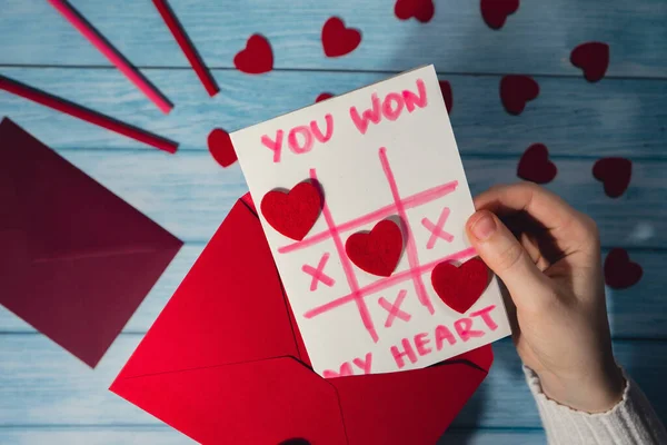 Valentines Day. Instructions for making valentine cards. Text YOU WON MY HEART and tic tac toe game Postcard craft, greeting card. DIY Step by step instruction. Making of handmade Valentine greeting card hobby concept, gift with your own hands.