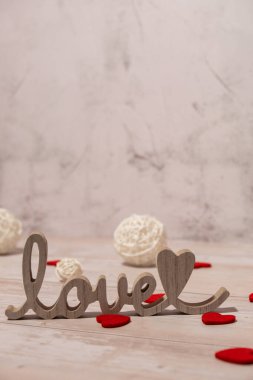Wooden word love with heart romance. Minimal concept of greeting card for Valentine's Day, Mother's Day, Women's Day Festive holiday card concept. Wedding anniversary decor.