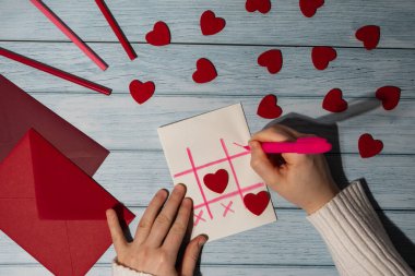 Valentines Day. Instructions for making valentine cards. Text YOU WON MY HEART and tic tac toe game Postcard craft, greeting card. DIY Step by step instruction. Making of handmade Valentine greeting card hobby concept, gift with your own hands.