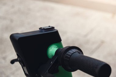 Electric scooter on the street with qr code on e-scooter, rental service app. Alternative transportation in city. Eco friendly transportation