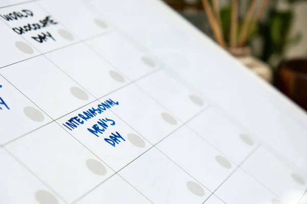 INTERNATIONAL MENS DAY on calendar to remind important event or holiday appointment Monthly PLANNER. Magnetic board with the days of the month. Place to enter important matters schedule. Concept for business planning. Whiteboard Planner magnetic mont