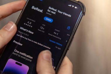 Gdansk Poland - October 2022. Girl holding smartphone with BeReal social media app on the screen on iPhone. BeReal is rising in popularity for its Time to BeReal is a French social media app that prompts users to take snapshot and post one unfiltered