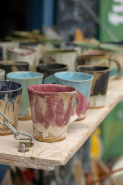 Gdansk, Poland - 9 August 2022 Polish culture - showcase with folk products on the street market. Hand painted mugs. Dominic's Fair in Gdansk Colorful collection of mugs on the counter of gift shop in Gdansk. Souvenir market. Tourist travel attractio