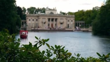 Baths classicist Palace on the Isle in Lazienki Park touristic place in Warsaw. Lazienki Royal Baths Park, Warsaw Poland. Mirror Reflection on the Lake. Nature in summer Baroque columns 