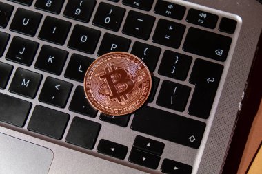 Bitcoin gold coin on keyboard of laptop Mining trading concept. BTC golden money. Worldwide virtual internet Cryptocurrency or crypto digital payment system. Digital coin money farm in digital cyberspace