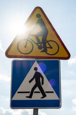 Round road sign depicting white bicycle on blue background, meaning mandatory bike path for cyclists against blue sky background. Blue round sign on bike path pole. Bike path