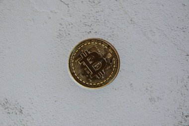 Bitcoin gold coin mining trading concept on concrete background. BTC golden money. Worldwide virtual internet Cryptocurrency or crypto digital payment system. Digital coin money farm in digital