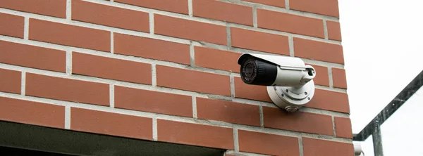 Close-up Of Security Camera On private building. Focus on security CCTV camera monitoring system with panoramic view. Technology concept. Surveillance video equipment outdoor safety system area