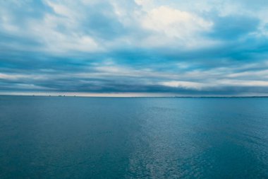 Vivid colourful clouds Dramatic Sky At Sunrise or Sunset. Blue sky with beautiful clouds in background. Gradient cold to warm. Defocused abstract background Natural texture Wallpaper. Amazing golden