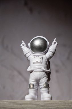 Plastic toy figure astronaut on moon concrete background Copy space. Concept of out of earth travel, private spaceman commercial flights. Space missions and Sustainability