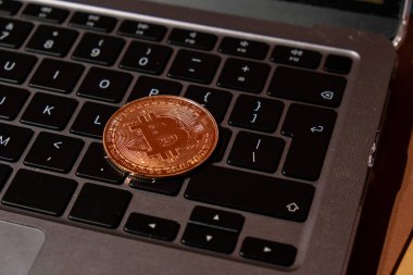 Bitcoin gold coin on keyboard of laptop Mining trading concept. BTC golden money. Worldwide virtual internet Cryptocurrency or crypto digital payment system. Digital coin money farm in digital
