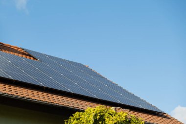 New ecologic house with solar panels Alternative to conventional energy. The battery is charged from a solar cell Advertisement Green energy Sustainable life Renewable alternative energy 