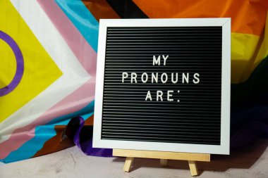 MY PRONOUNS ARE text Neo pronouns concept on Rainbow flag background gender pronouns. Non-binary people rights transgenders. Lgbtq community support assume my gender, respect pronouns tolerance equal clipart