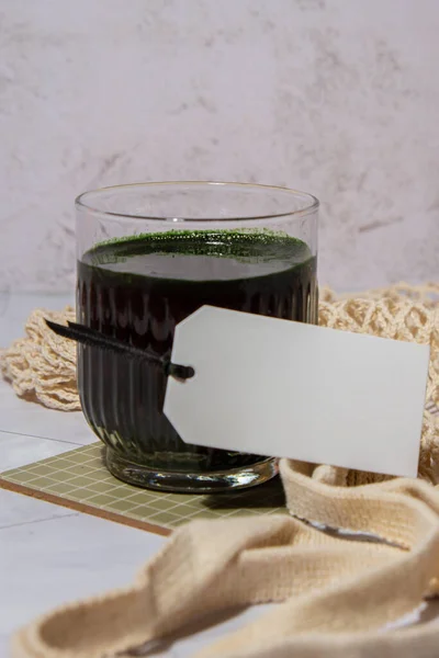 Blue-green algae Chlorella and spirulina powder drink with empty paper note copy space. Super powder. Natural supplement of algae. Detox superfood drink cocktail. Food supplement source of protein and