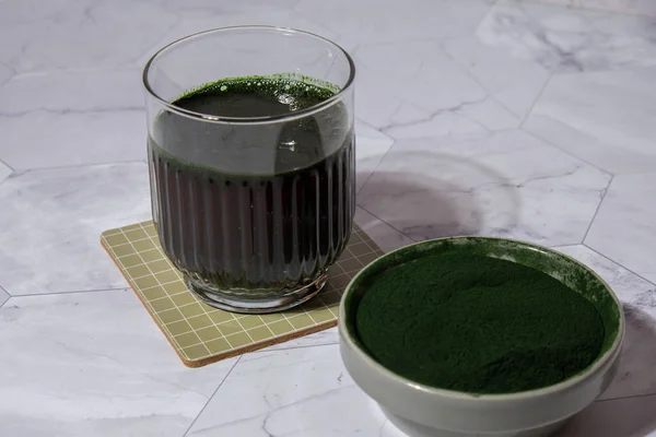 Blue-green algae Chlorella and spirulina powder drink. Super powder. Natural supplement of algae. Detox superfood drink cocktail. Food supplement source of protein and beta carotene. Healthy food