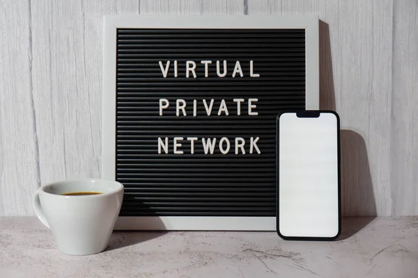 Letter board with text of VIRTUAL PRIVATE NETWORK VPN with mobile phone white screen mock up template for your copy space app application creation Internet protocols for protection private network