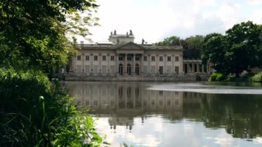 Baths classicist Palace on the Isle in Lazienki Park touristic place in Warsaw. Lazienki Royal Baths Park, Warsaw Poland. Mirror Reflection on the Lake. Nature in summer Baroque columns 