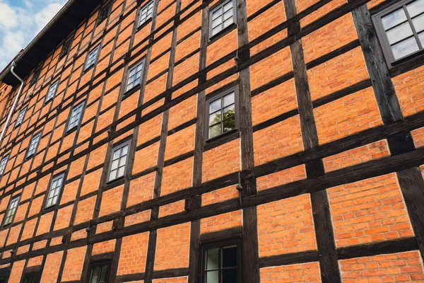 Former Rother Mills building complex made of characteristic brick and a half-timbered structure situated on the Mill Island Old town Bydgoszcz, Poland. Facade of the complex of ancient mills