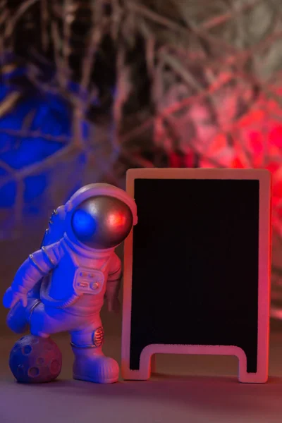 Plastic Toy Figure Astronaut Red Blue Light Black Board Copy — Stockfoto