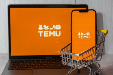Gdansk, Polonya - Mart 2023 Temu uygulama simgesi MacBook Apple bilgisayar dizüstü bilgisayarı ve alışveriş arabalı cep telefonu ekranında. Çin merkezli Pinduoduo e-ticaret platformunun Temu yan kuruluşu. İnternetten alışveriş