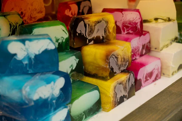 Handmade aromatic soap. Selective focus. Soaps and cosmetics handmade on street market festival. Craft soap bars at traditional store counter. Pyramid of handmade soap with natural additives and