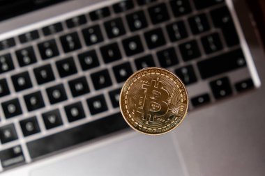 Bitcoin gold coin on keyboard of laptop Mining trading concept. BTC golden money. Worldwide virtual internet Cryptocurrency or crypto digital payment system. Digital coin money farm in digital