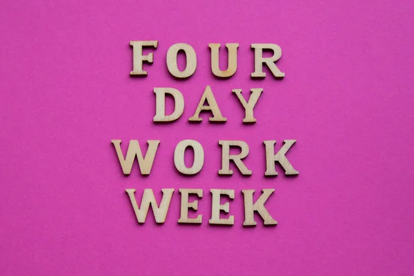 4 day work week symbol wooden letters four day working week concept. Modern approach doing business short workweek. Effectiveness of employees. Productivity and efficiency days off