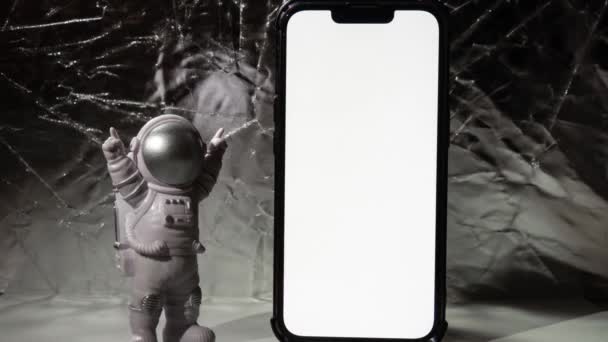 Stop Motion Plastic Toy Figure Astronaut Mobile Phone White Screen — Stock Video