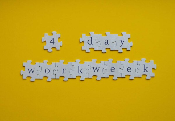 4 day work week symbol on puzzles four day working week concept. Modern approach doing business short workweek. Effectiveness of employees. Productivity and efficiency days off 