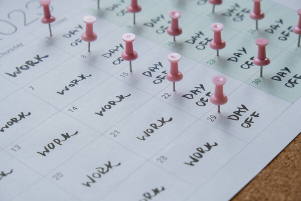 4 day work week printed calendar with pink pins on three days off in week weekend days four day working week concept. Modern approach doing business short workweek. Effectiveness of employees