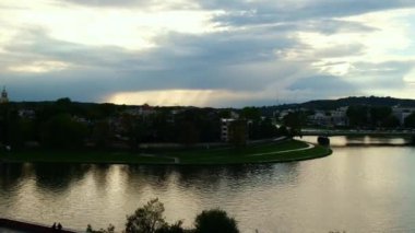 Heavy rain and rainbow above the Vistula river in Krakow Poland. Stunning views of the city rainy season and rainbow. Sky, panoramic views. 