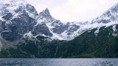 Tatra National Park, Poland. Famous Mountains Lake Morskie Oko Or Sea Eye Lake In autumn. Snow covered mountain peaks on background. Blue water nature landscape 4k