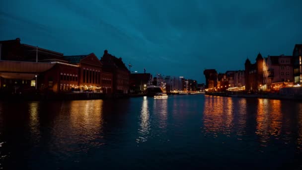 グダニスクポーランド2022年3月夜間反射でグダニスクの旧市街で夜の観覧車の時間経過 モトラワ川沿いの船レストラン — ストック動画