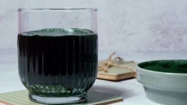 Blue-green algae Chlorella and spirulina powder add to drink. Super powder. Natural supplement of algae. Detox superfood drink cocktail. Food supplement source of protein and beta carotene. Healthy