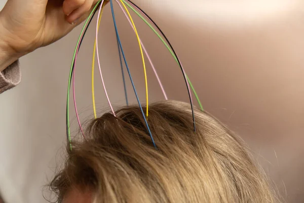 stock image Unrecognizable woman enjoying scalp massage through massager at home. Close up of using scalp massaging brush with long hair, hair growing routine. Anti stress acupuncture metal octopus tool equipment