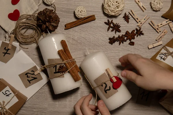 stock image Unrecognizable young woman paint numbers on candles. Female making homemade advent calendar Made with your own hands step by step DIY crafts do it yourself. Preparation to christmas concept. Seasonal