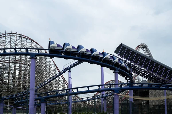 stock image Riding the roller coaster at Energylandia Zator Poland amusement park. Solar powered roller coaster. Rollercoaster against blue sky sunset Wooden outdoor leisure family time 