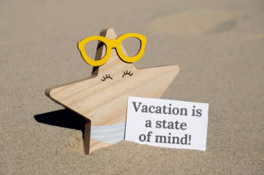 Tatil, yaz tatilinde gözlüklü komik denizyıldızının arka planında kağıt üzerine yazılmış bir zihin mesajı durumudur. Kumsalın güneş kıyısı. Tatil konsepti kartpostalı. Kaçmak Seyahat İşi