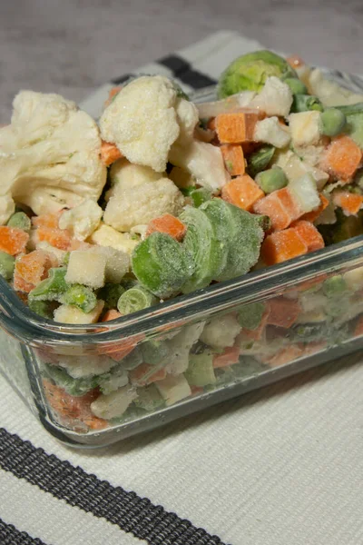 Frozen mixed vegetables for long-term storage. Deep freezing of vegetables. defrosting Frozen food vegetables background